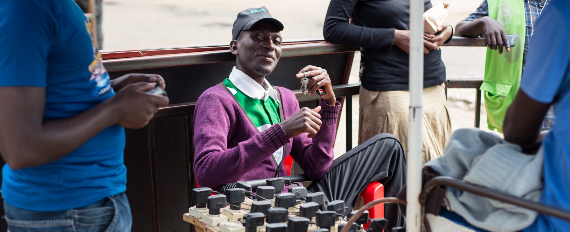 Photo of Amid underdevelopment of the power grid and landline systems, smartphone charging services are flourishing on the streets. Smartphones have spread rapidly, and are dominating financial transactions. The current African economy is mirrored in everyday scenes like this. (Photo taken near Lake Kivu in Rwanda)