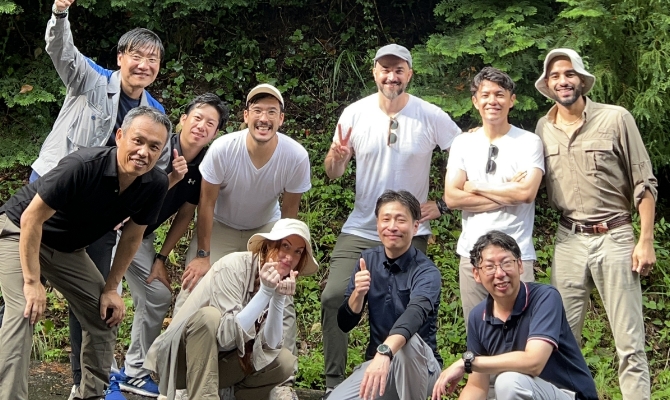 投資した独スタートアップ「LiveEO」のチームが九州を訪れ、九電グループ側のメンバーと佐賀の山中で現場検証を行った。「私たちが目指すスタートアップとの関係性」と荒木さん（前列左端）の画像